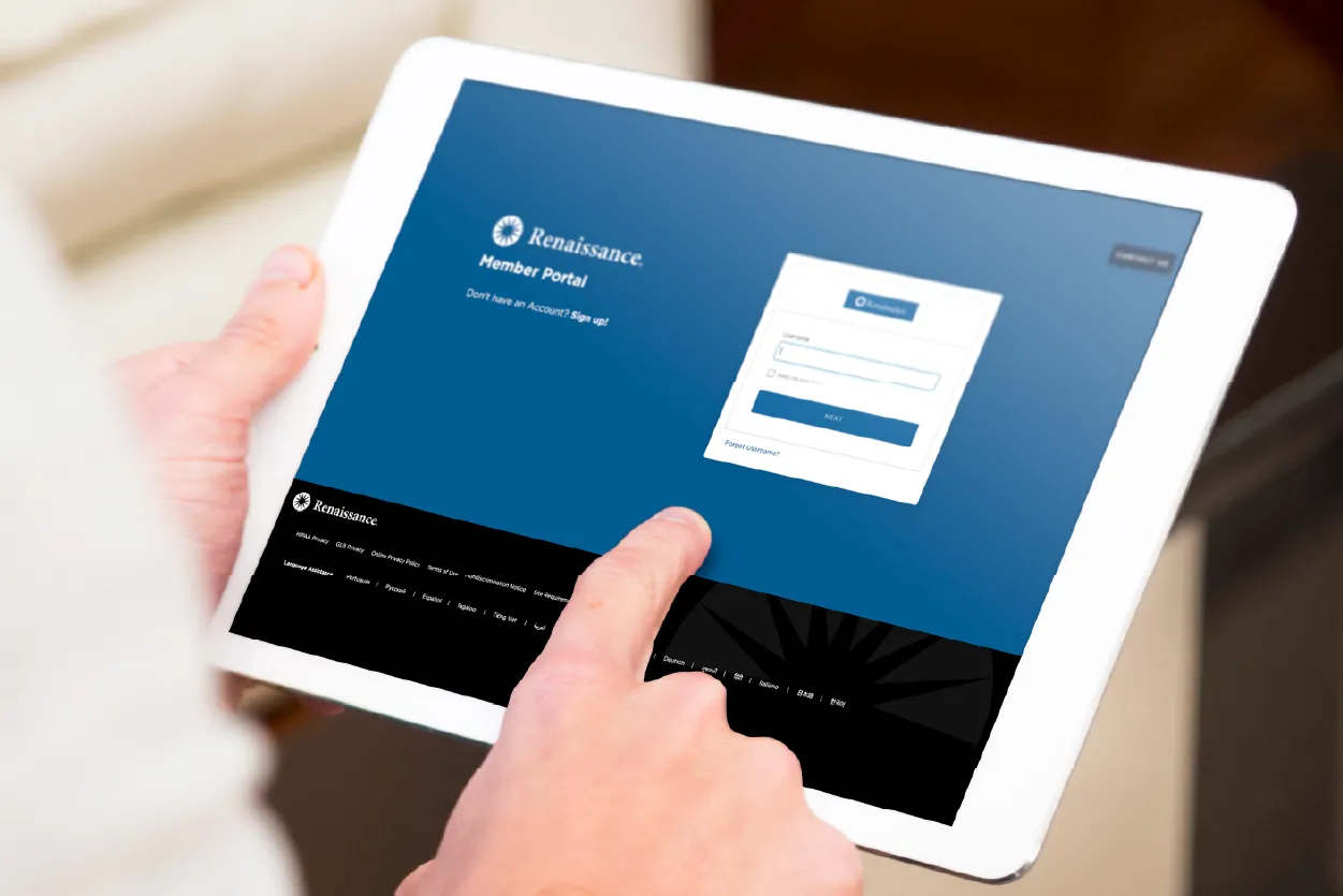 Close-up of hands holding a tablet displaying a member portal login screen, with a finger touching the screen.