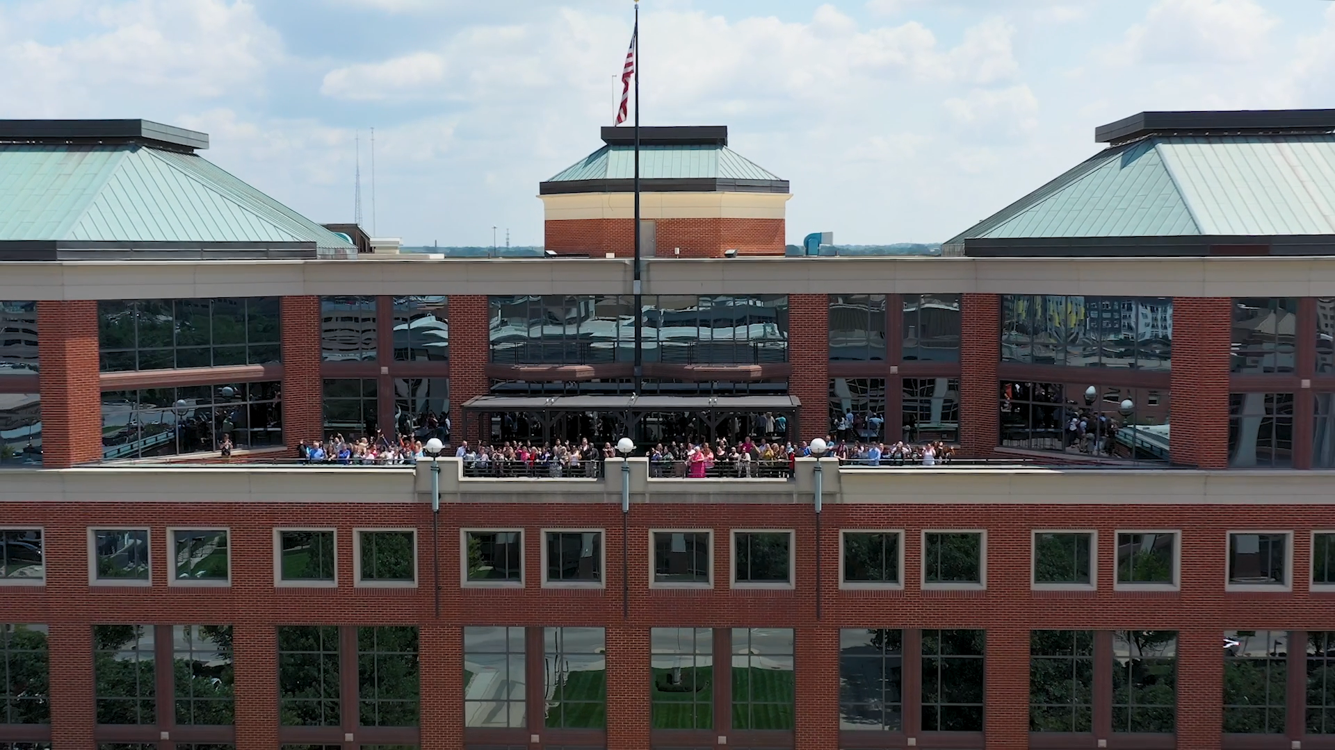 Drone image of Renaissance corporate office building with employees standing on the deck.