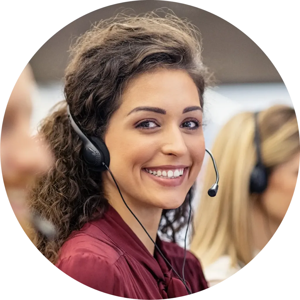 Woman smiling at the camera wearing a headset.