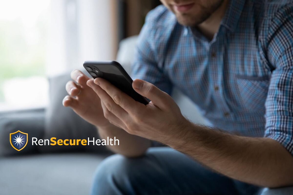 Closeup of man holding phone with RenSecureHealth logo overlayed