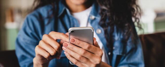 Person smiling while using a smartphone